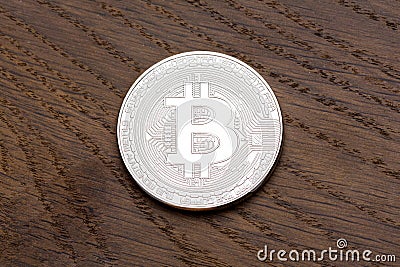 Digital currency physical silver bitcoin on the wood. Stock Photo