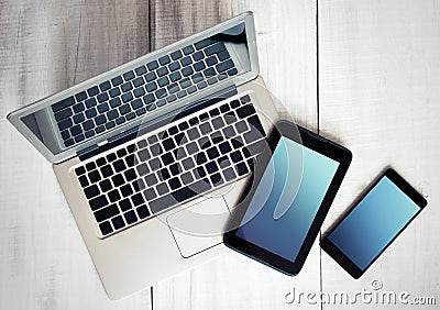 Digital electronic devices phone tablet laptop on wood. Stock Photo