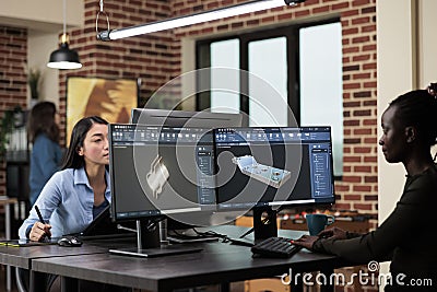 Digital engineer developing prototype mesh using modern computer while sitting at desk in office. Stock Photo