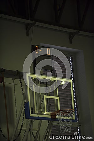 Digital indoor small scoreboard score. Basketball players are on a field. Stock Photo