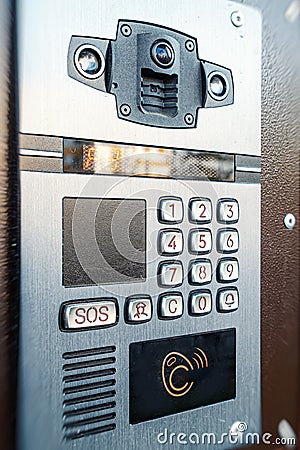 Digital intercom with the ability to record incoming calls to the house. Buttons for entering the code and a magnetic Stock Photo