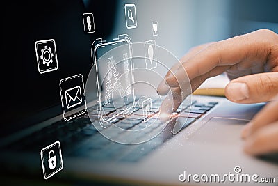 Digital interface icons floating above a laptop keyboard with a user hand interacting with the device Stock Photo