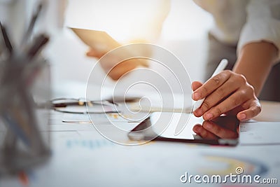 Digital marketing, businessman using digital tablet and documents on office desk background. Stock Photo