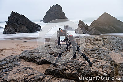 Digital mirrorless photo camera on flexible tripod Stock Photo