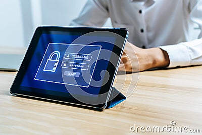 Digital mobile tablet with login page interface on desk with employee in meeting room office Stock Photo