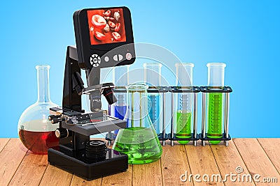 Digital modern microscope with chemical flasks on the wooden ta Stock Photo