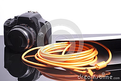 Digital photo camera connected to laptop Stock Photo