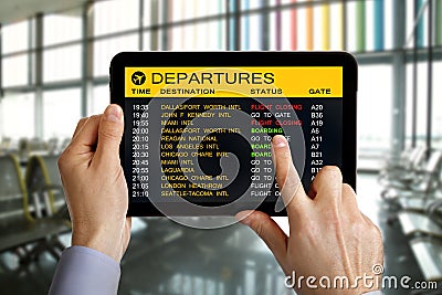 Digital tablet in airport with flight information Stock Photo