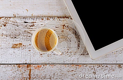 Digital tablet and coffee cup on old wite table Stock Photo