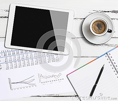 Digital tablet and coffee cup on wooden table Stock Photo