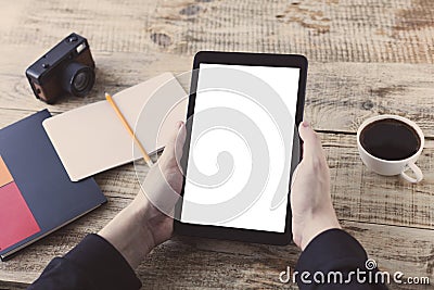 Digital tablet computer, isolation screen in male hands over cafe background - table wooden plancs, cup of coffee, nootbook, penci Stock Photo