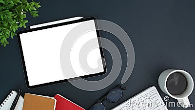 Tablet, cup of coffee, notebook and glasses on black leather. Top view with copy space, flay lay. Stock Photo