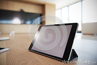 Digital Tablet On Empty Boardroom Table In Office Stock Photo