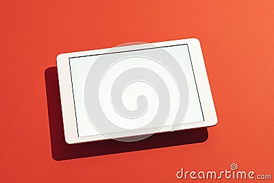 Digital tablet mockup on red background, floating, high angle view Stock Photo