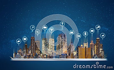 Digital tablet with modern buildings hologram and technology icons. Smart city, internet and networking smart technology Stock Photo