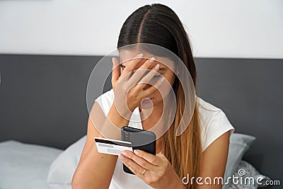 Digital theft. Desperate girl finds out that her credit card was cloned and her bank account emptied. Cyber security concept Stock Photo