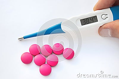 Digital thermometer and pills Stock Photo