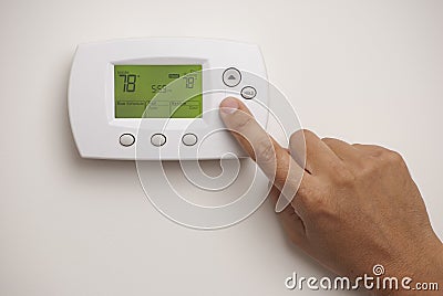 Digital Thermostat and male hand Stock Photo