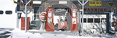 Digitally altered view of a vintage gas station with old style pumps and many old fashioned signs Editorial Stock Photo