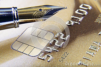 Digits and pen on credit card close-up Stock Photo