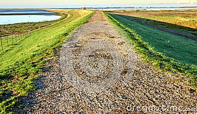 Dike on the island of Sylt between the Wadden Sea of the North Sea and the nature reserve of the Rantum Basin, Germany Stock Photo