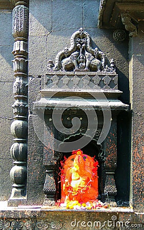 ganpati bappa Indian vintage temple (Hindu god) sculpture orange vintage old temple Stock Photo