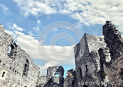 Dilapidated castle on the mountain, ruins and blue sky Stock Photo