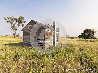 Dilapidated house in field. Stock Photo