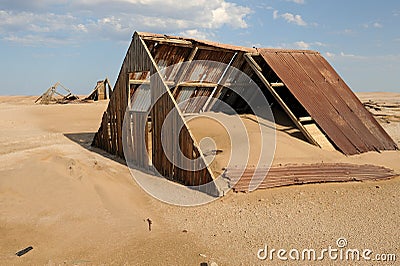 Dilapidated ruin of an old house in a derelict mining settlement Stock Photo