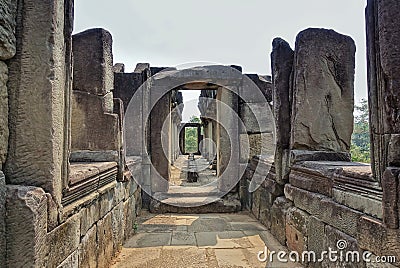 A dilapidated stone corridor at the top of the temple. Doorways, windows, columns are damaged by time. Stock Photo