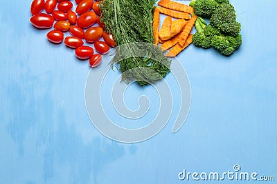 dill. baby tomatoes. carrot. broccoli. on wood blue sky background. space Stock Photo
