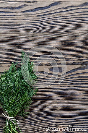 Dill bunch on rustic wood background. Stock Photo