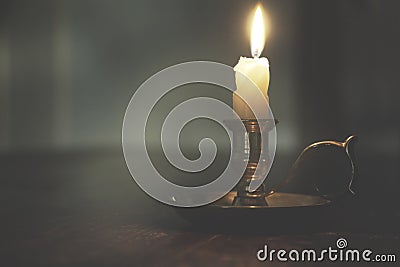 Dim light of a candle in a mysterious night, concept of spirituality and hope Stock Photo