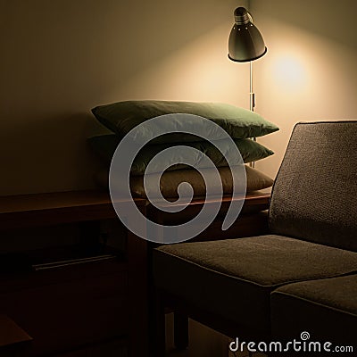 A dim shaded view of sofa with a stack of pillows. Stock Photo