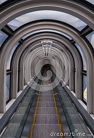 Diminishing perspective in a futuristic escalator tube Stock Photo