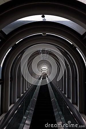 Diminishing perspective in a futuristic escalator tube Stock Photo