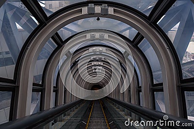 Diminishing perspective in a futuristic escalator tube Stock Photo