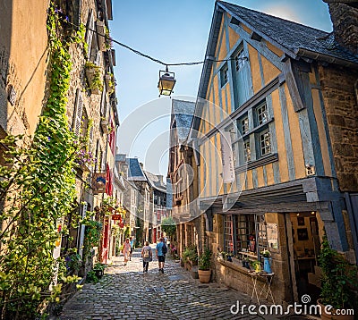 Colorful half-timbered houses and shops along historical street in Dinan. Editorial Stock Photo