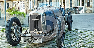 Front of classic french CG Amilcar race cabriolet car from the 30th with crank handle motor starter in village Editorial Stock Photo