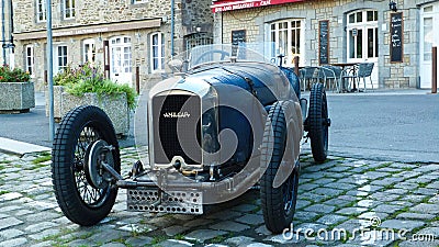 View on front of classic french Amilcar cabriolet car from the 30th with crank handle motor starter typical in village focus on c Editorial Stock Photo
