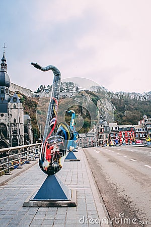 DINANT, BELGIUM - Feb 19, 2014: Saxophone statue on the bridge village Editorial Stock Photo
