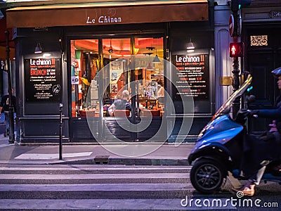 Diners lounge inside Le Chinon, a Paris bistrot Editorial Stock Photo