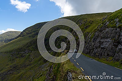 Cars try to pass each other on the very narrow road leading to Connor Pass on the Dingle Peninsula in County Kerry Editorial Stock Photo