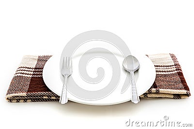 Dining place setting. A white plate with silver fork and spoon Stock Photo