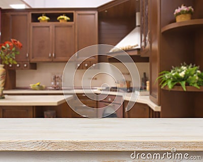 Dining table on blurred brown kitchen interior background Stock Photo