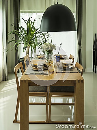 Dining table and comfortable chairs in modern home Stock Photo