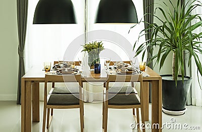 Dining table and comfortable chairs in modern home Stock Photo