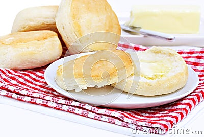 Dinner biscuits, one with melting butter. Stock Photo