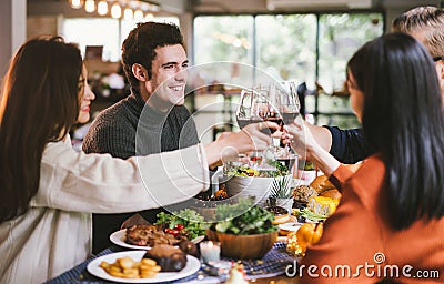 Dinner with friends. Group of young people enjoying dinner together. Dining Wine Cheers Party thanksgiving Concept. Stock Photo