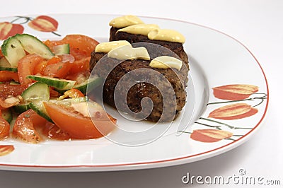 Dinner plate with kebab and vegetables Stock Photo